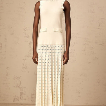 A long white knitted maxi dress with faux pearl embellishments