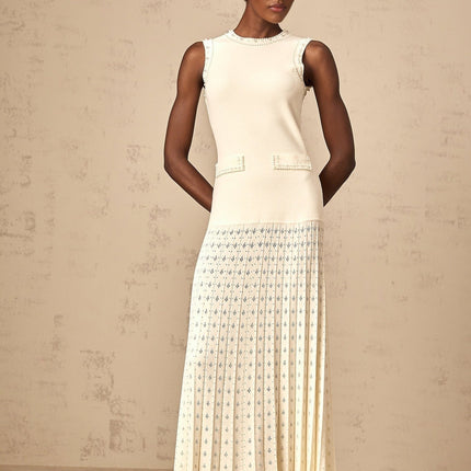 A long white knitted maxi dress with faux pearl embellishments