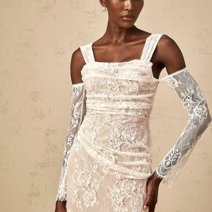 A long white maxi dress with a corset bodice featuring ruched floral lace detailing and a fitted silhouette named Berenice