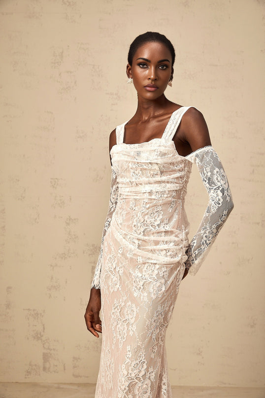 A long white maxi dress with a corset bodice made of floral lace featuring ruched details named Berenice