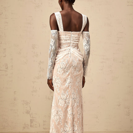 A long white maxi dress with a floral lace pattern featuring a corset bodice and ruched detailing named Berenice