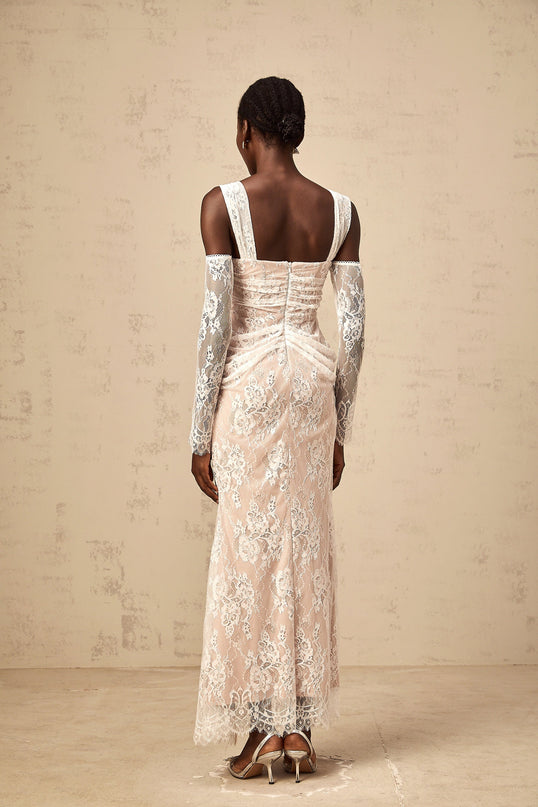 A long white maxi dress with a floral lace pattern featuring a corset bodice and ruched detailing named Berenice