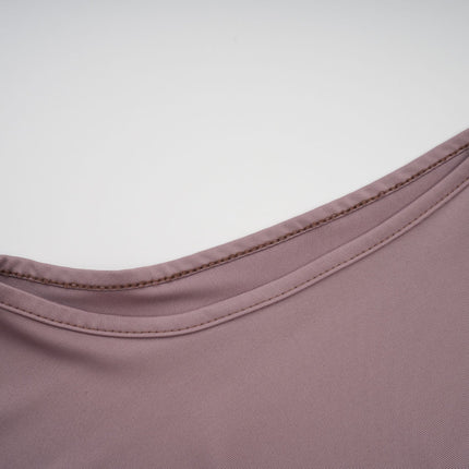 A long white maxi dress with a wavy lace pattern covering the entire garment featuring a feminine silhouette and delicate details