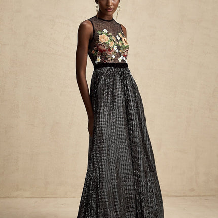 A long white maxi dress with colorful floral embroidery and embellishments covering the fabric