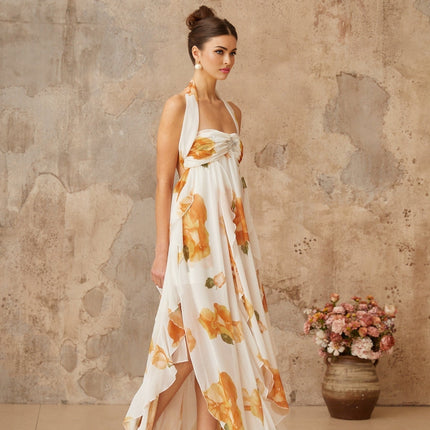 A long white maxi dress with floral print and ruffled tulle details featuring a fitted bodice and flowing skirt