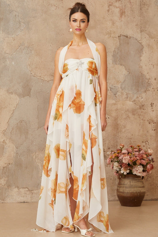 A long white maxi dress with floral print and ruffled tulle details featuring a romantic and ethereal design