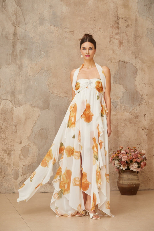 A long white maxi dress with floral print and ruffled tulle details featuring a romantic and feminine design