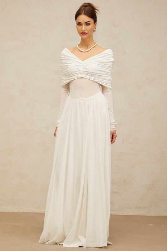 A long white maxi dress with ruched detailing and draped elements featuring a flowing silhouette