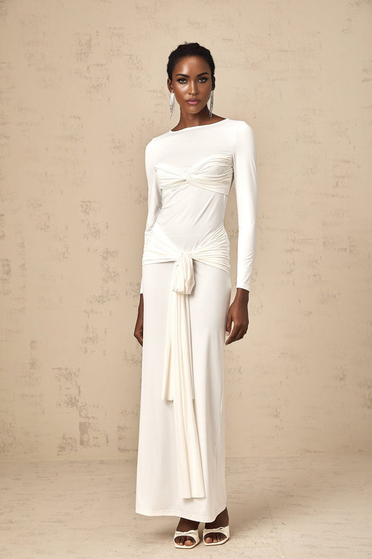 A long white maxi dress with ruched fabric and a ribbon twist detail