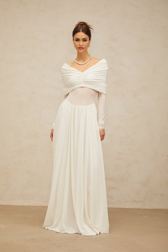 A long white maxi dress with ruched fabric and draped details