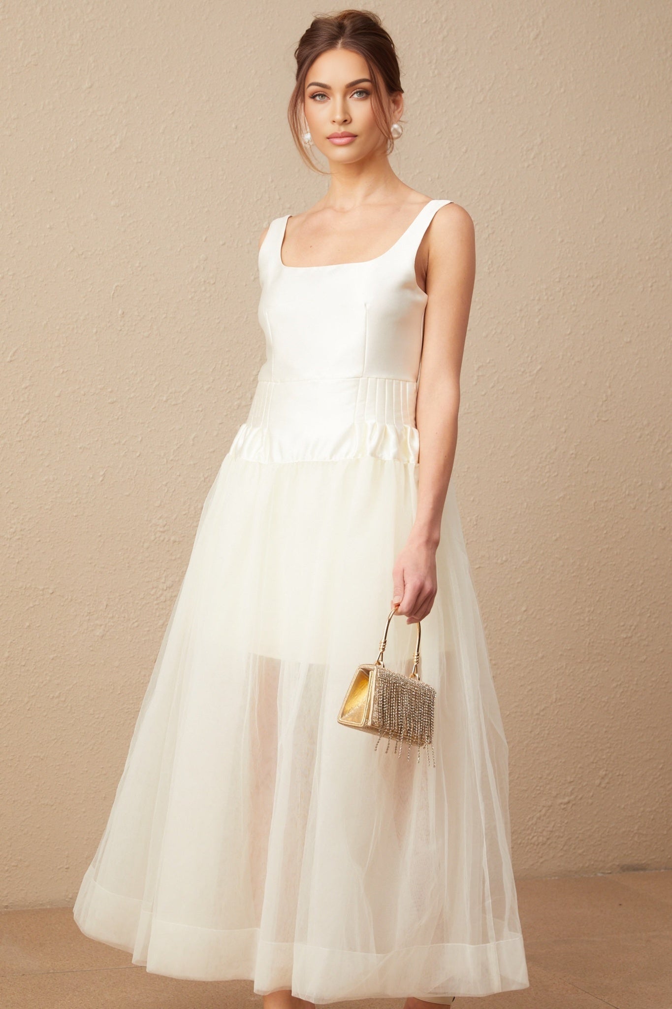 A long white maxi dress with satin and tulle panels named Lucie featuring a sleek silhouette and elegant design