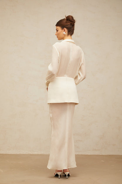 A long white maxi dress with sheer panels and a flowy silhouette