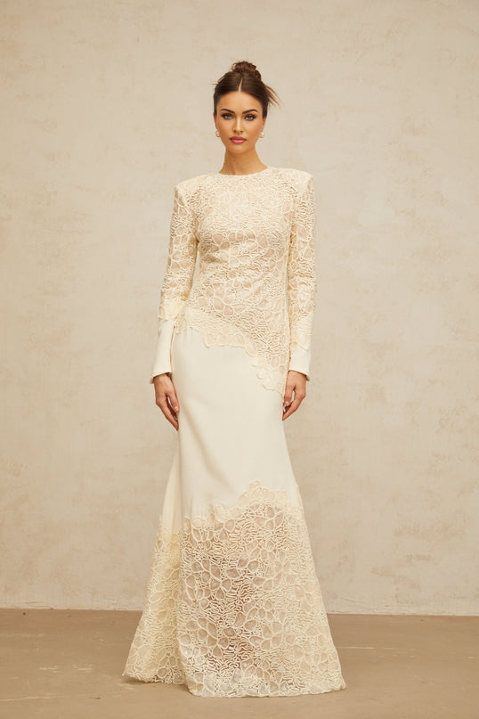 A long white maxi dress with textured floral embroidery and sequin details named Mathilde