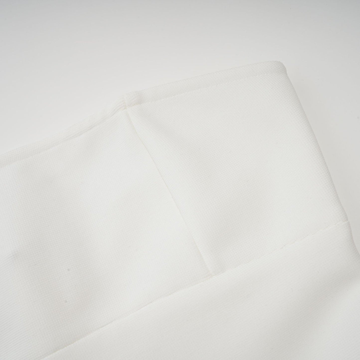 A long white maxi dress with tulle panelling named Nathalie featuring a flowy silhouette and delicate sheer details