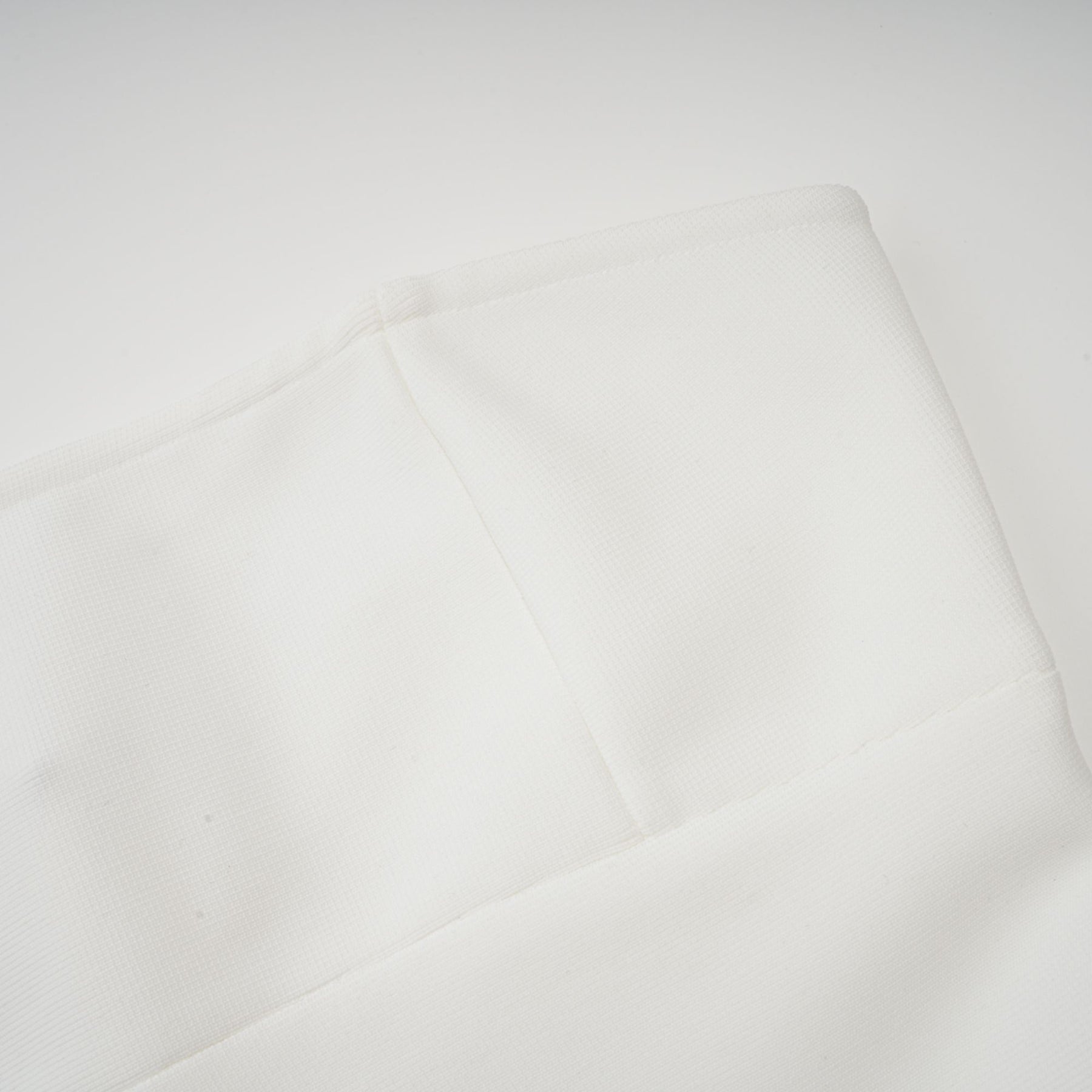 A long white maxi dress with tulle panelling named Nathalie featuring a flowy silhouette and delicate sheer details