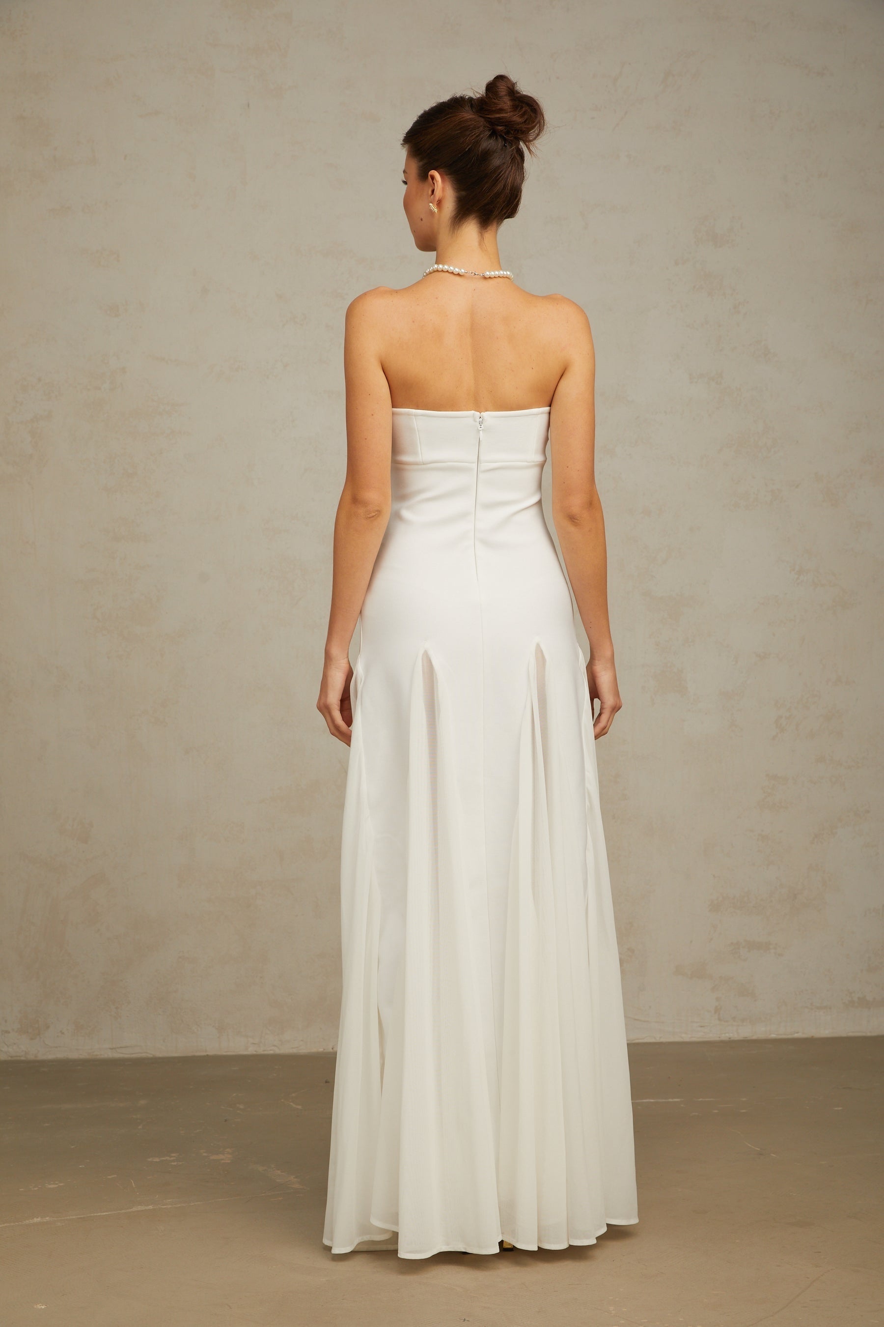 A long white maxi dress with tulle panels named Nathalie featuring a flowy silhouette and delicate feminine design