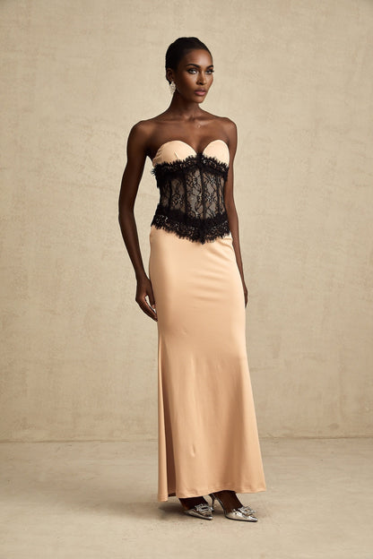 A long white off shoulder maxi dress with lace panels and a corset style bodice featuring a fitted silhouette and flowy skirt
