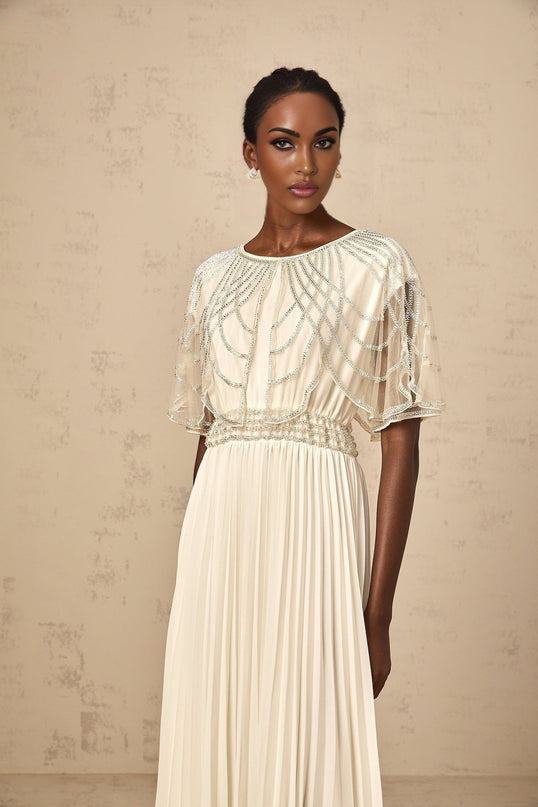 A long white pleated maxi dress with crystal embellishments called Xenia