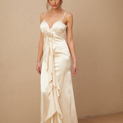 A long white satin maxi dress with a corset bodice featuring colorful floral applique details and a flowing skirt