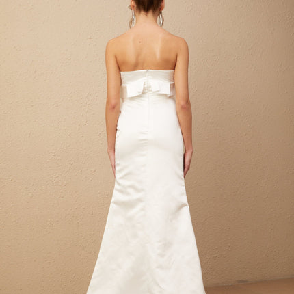 A long white satin maxi dress with floral applique details featuring a design inspired by Anna