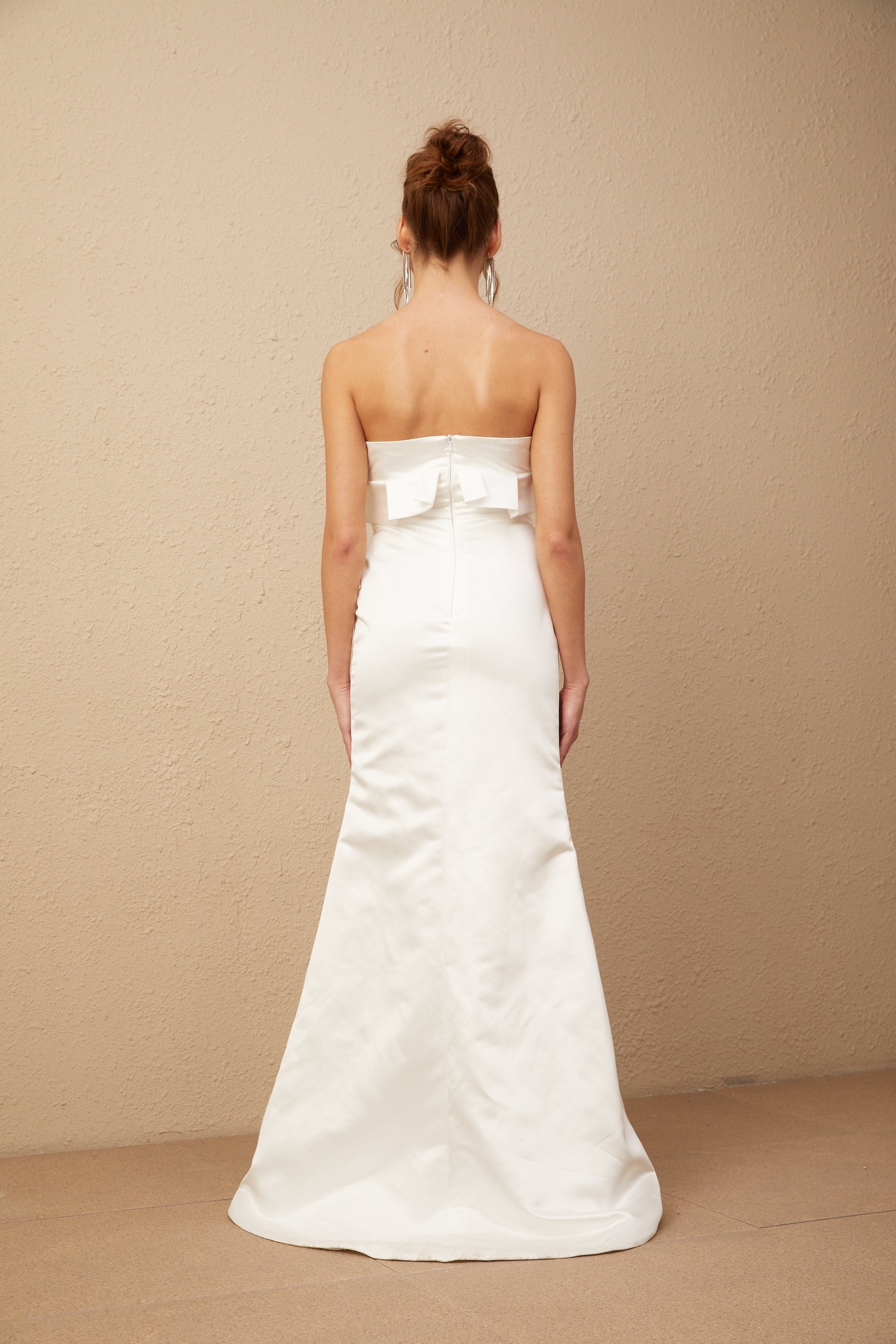 A long white satin maxi dress with floral applique details featuring a design inspired by Anna