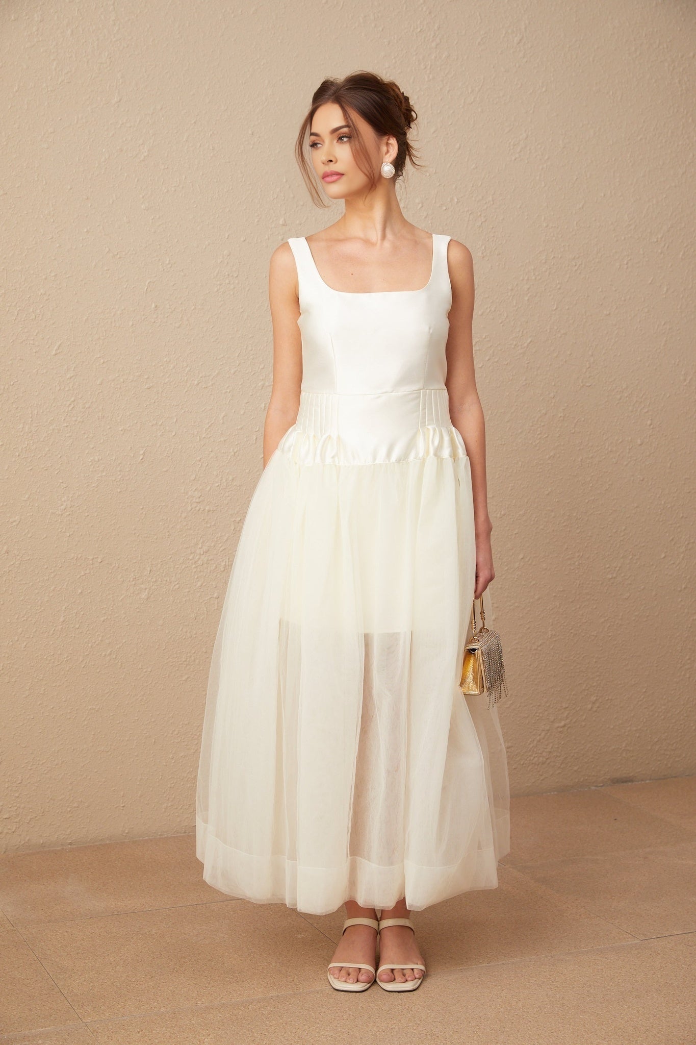 A long white satin maxi dress with tulle panels named Lucie featuring a flowy silhouette and elegant design