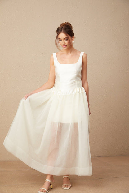 A long white satin maxi dress with tulle panels named Lucie featuring a sleek and elegant design suitable for formal occasions