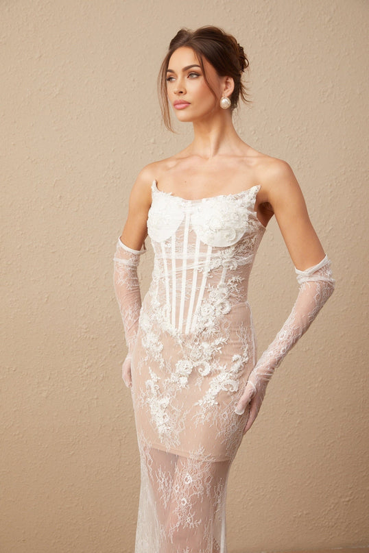 A long white tulle maxi dress with a corset bodice featuring colorful floral embroidery and thin straps