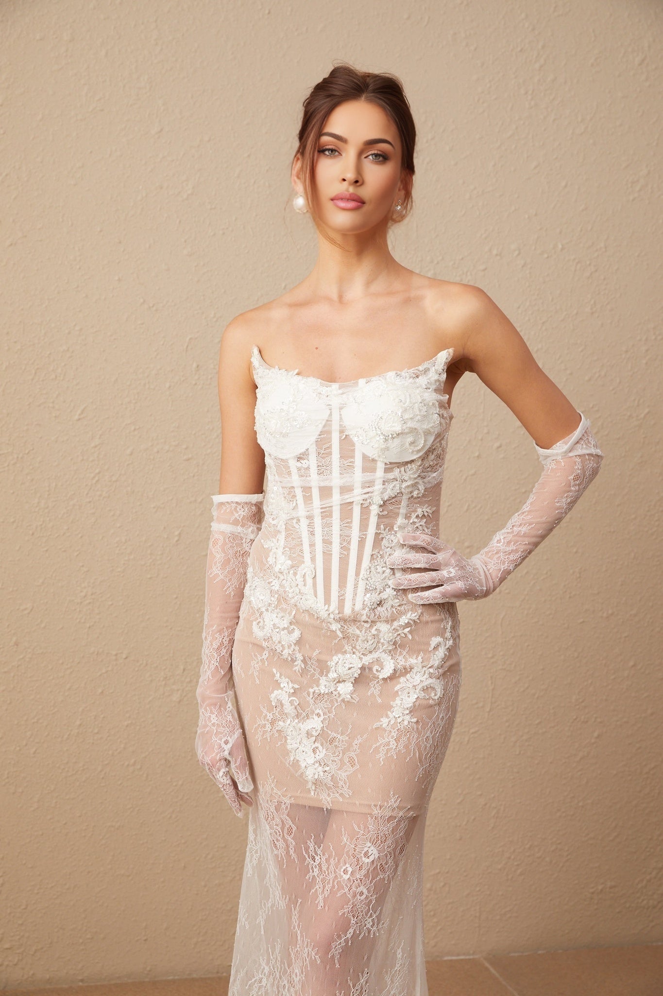 A long white tulle maxi dress with a corset bodice featuring colorful floral embroidery and thin straps