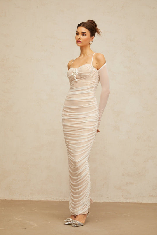 A long white tulle maxi dress with a ruched bustier top and flowing skirt