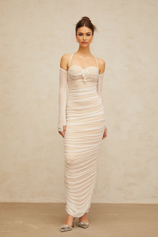 A long white tulle maxi dress with a ruched bustier top and flowing skirt