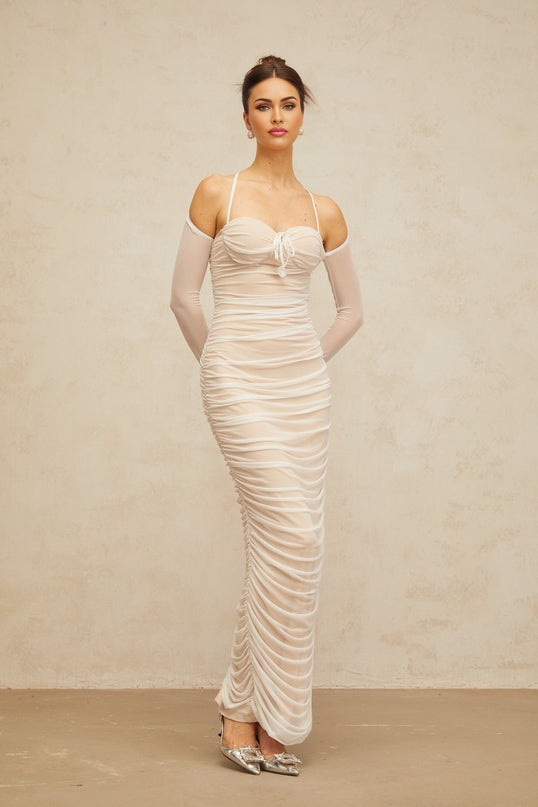 A long white tulle maxi dress with a ruched bustier top and flowy skirt