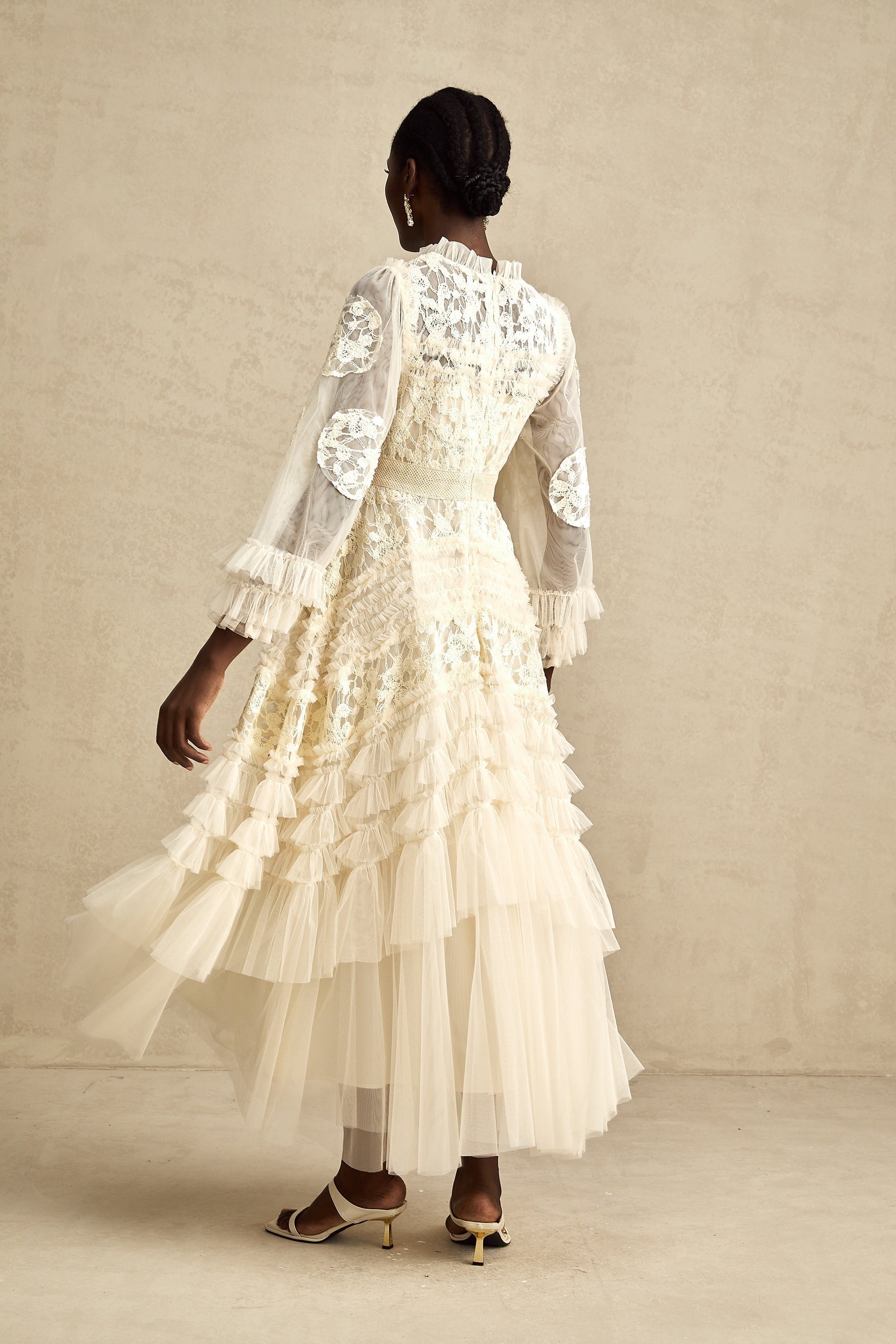 A long white tulle maxi dress with layered skirt featuring delicate floral embroidery in pastel colors named Capucine