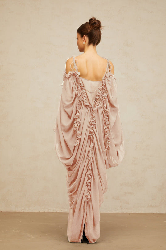 A long white tulle maxi dress with ruffled trim details and a flowy silhouette