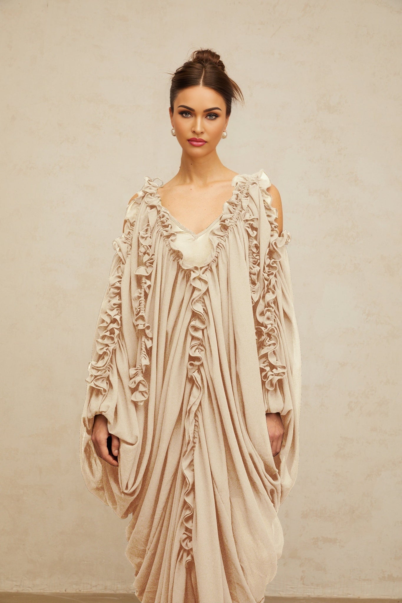A long white tulle maxi dress with ruffled trim details and a flowy silhouette