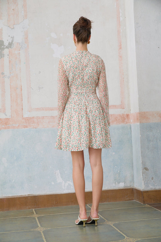 A Marion mini dress with a floral print pattern and pleated design on a white background