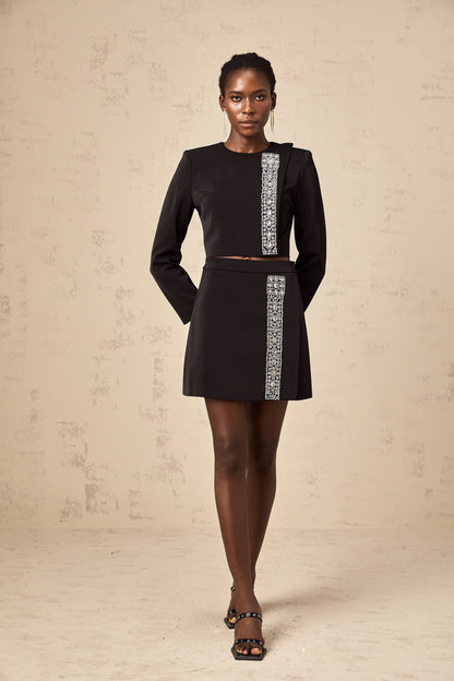 A matching set consisting of a black top and skirt embellished with crystal details named Nadia The top and skirt are coordinated to create a stylish ensemble