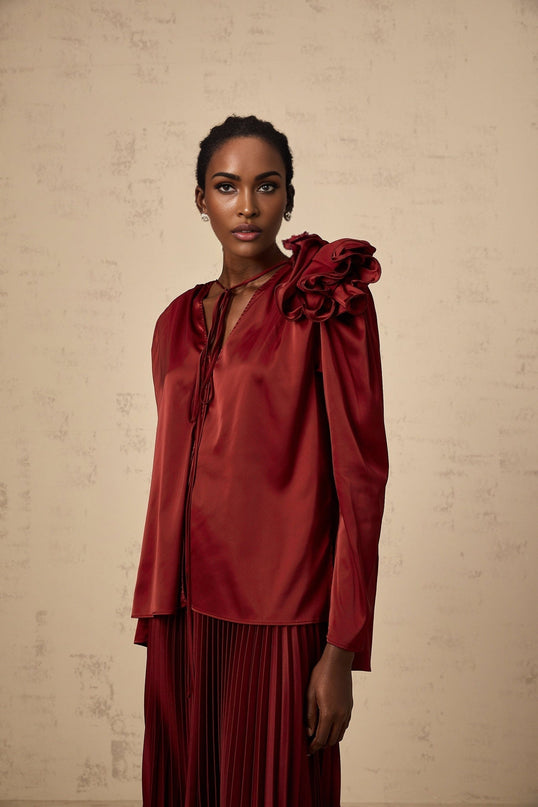 A matching set consisting of a blouse and skirt in satin fabric with floral applique details named Colette