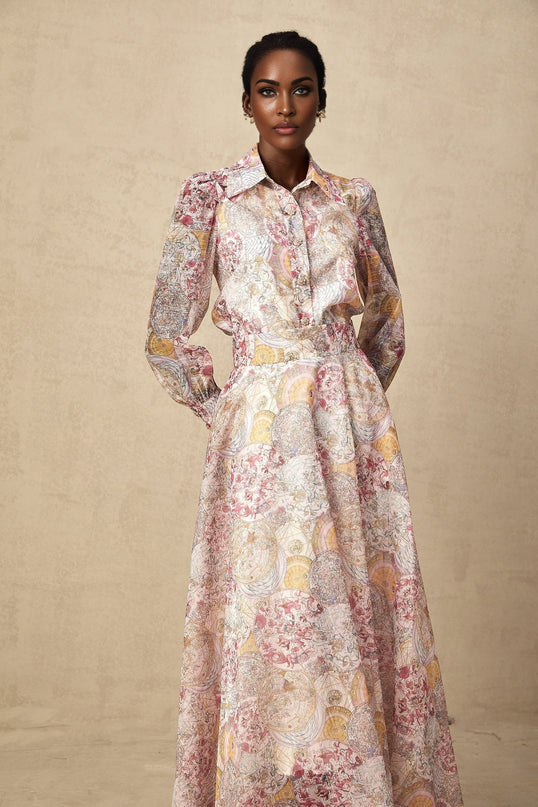 A matching set consisting of a cherry pink shirt and skirt both featuring a printed pattern design