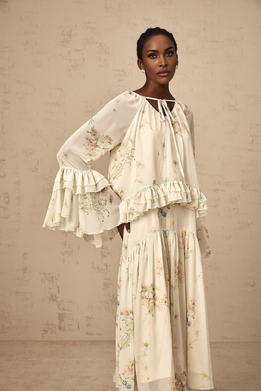 A matching set consisting of a floral print blouse with ruffles and a coordinating dress both featuring a Melissa design