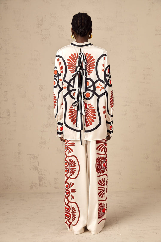 A matching set consisting of a shirt and trousers with a graphic print design called Amaranta The outfit features a coordinated pattern on both pieces