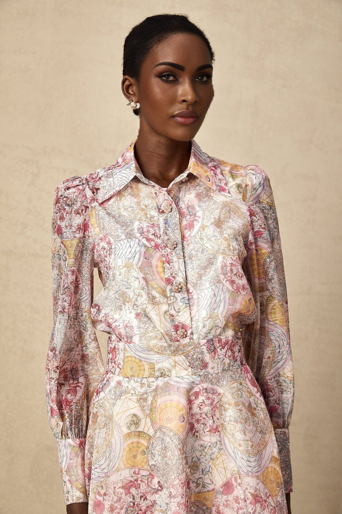 A matching set featuring a cherry pink shirt and skirt with a pattern print design