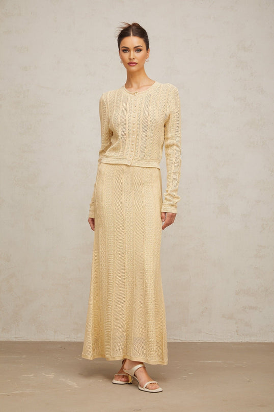 A matching set featuring a pointelleknit cardigan and skirt in a coordinated style named Tiphaine The set showcases delicate openwork patterns throughout both pieces