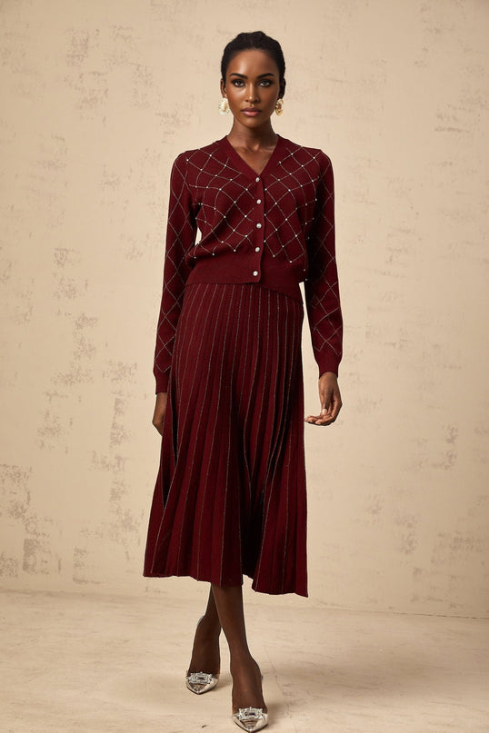 A matching set featuring a red cardigan and skirt with argyle intarsia knit pattern and embellishments The cardigan has long sleeves and the skirt is knee length Both pieces showcase a classic argyle design in red and white with sparkly embellishments for added glamour