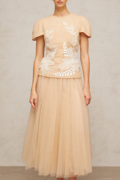 A matching set featuring a tulle top and skirt with floral applique details named Ludivine The ensemble has a delicate and feminine appearance with a sheer overlay adorned with floral embellishments