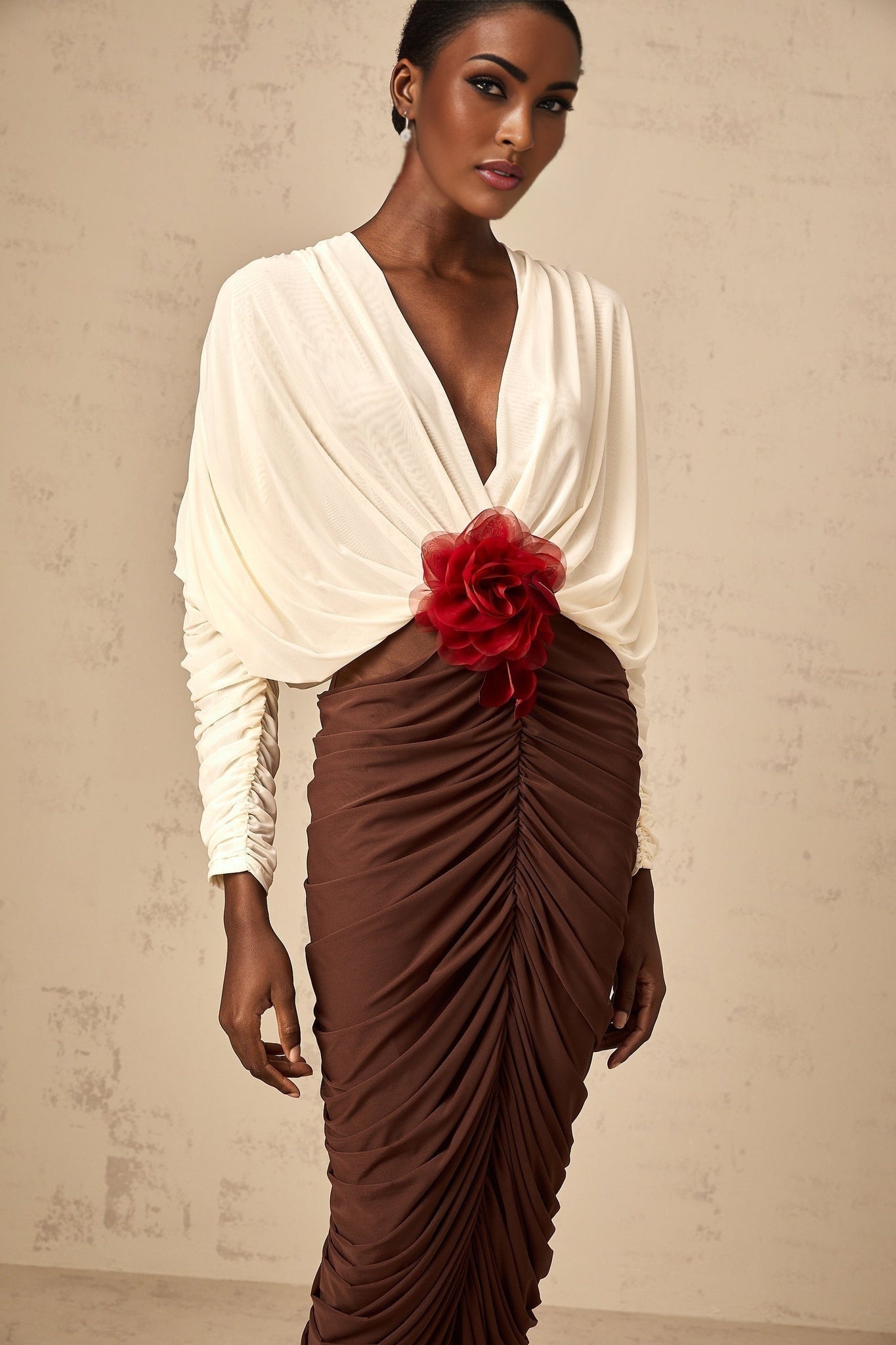 A midi dress featuring color blocking and a flower brooch with ruched detailing named Leontine