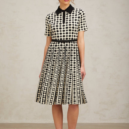 A midi dress with color blocking and polka dot patterns on a knit fabric featuring different sections in contrasting colors and prints