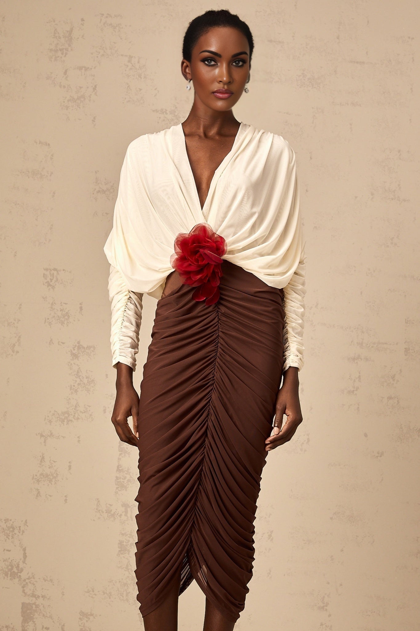 A midi dress with color blocking and ruching featuring a flower brooch detail named Leontine