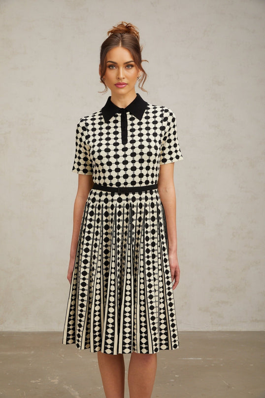 A midi dress with colorblocked sections and polka dot pattern featuring a knit fabric design in multiple colors