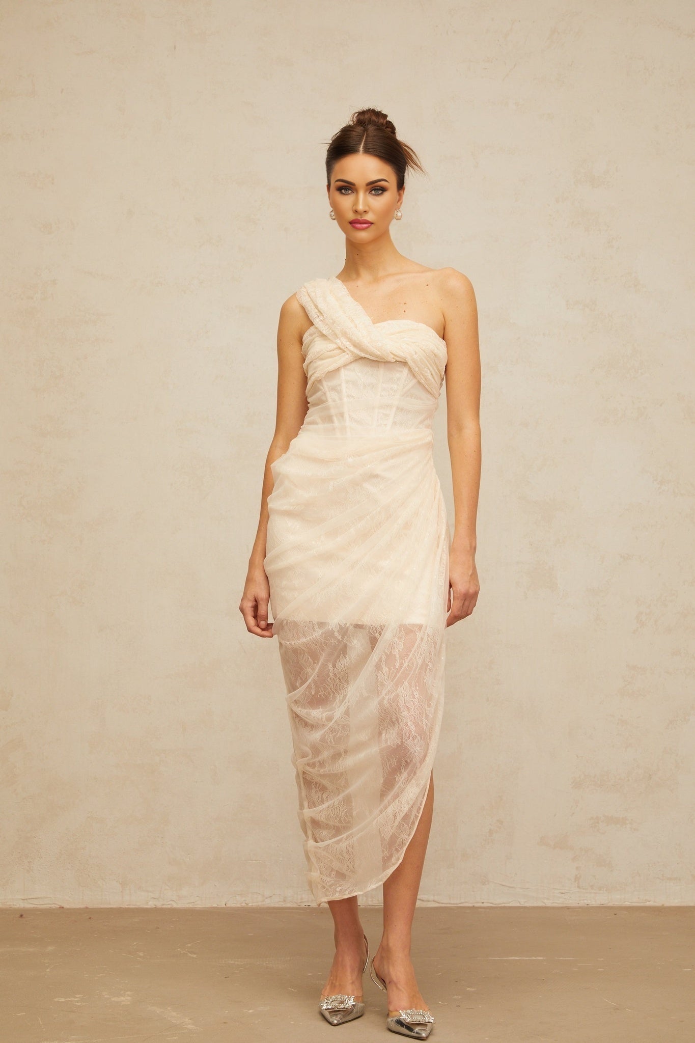 A midi dress with floral lace pattern and gathered tulle panels featuring a petunia inspired design